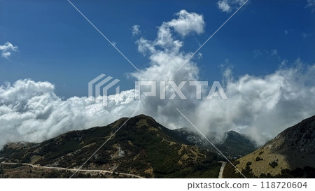 Rolling Clouds Over Mountain Range Rolling Clouds Over Mountain Range 118720604