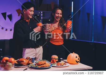 Joyful office Halloween party with coworkers in costumes, celebrating with drinks and laughter, fostering teamwork and festive spirit Joyful office Halloween party with coworkers in costumes, celebrating with drinks and laughter, fostering teamwork and festive spirit 118720987