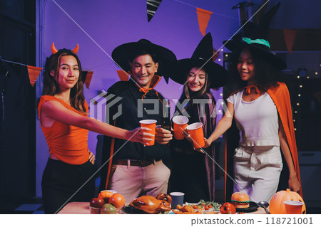 Joyful office Halloween party with coworkers in costumes, celebrating with drinks and laughter, fostering teamwork and festive spirit 118721001