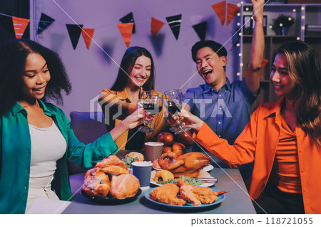 Joyful office Halloween party with coworkers in costumes, celebrating with drinks and laughter, fostering teamwork and festive spirit 118721055