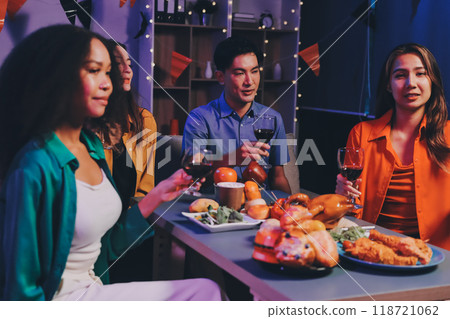 Joyful office Halloween party with coworkers in costumes, celebrating with drinks and laughter, fostering teamwork and festive spirit 118721062