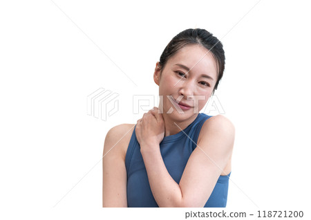 A woman in sportswear massaging her shoulders A woman in sportswear massaging her shoulders 118721200