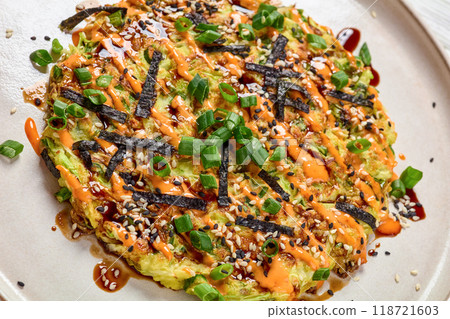 Japanese pancake with cabbage on a plate, top view 118721603