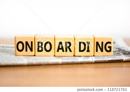 Onboarding success symbol. Concept word Onboarding on wooden blocks. Beautiful wooden table white background. Newspaper. Business onboarding success concept. Copy space. 118721783