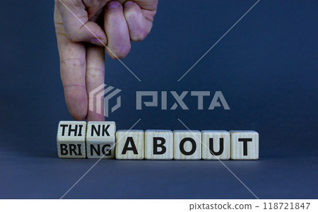 Think or bring about symbol. Businessman turns wooden cubes and changes words 'think about' to 'bring about'. Beautiful grey table, grey background, copy space. Business, think or bring about concept. Think or bring about symbol. Businessman turns wooden cubes and changes words 'think about' to 'bring about'. Beautiful grey table, grey background, copy space. Business, think or bring about concept. 118721847
