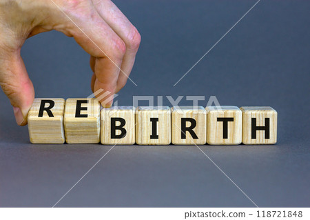 Birth or rebirth symbol. Businessman turns wooden cubes and changes the word birth to rebirth. Beautiful grey table grey background, copy space. Business, birth or rebirth concept. 118721848