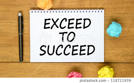 Exceed to succeed symbol. Concept words Exceed to succeed on beautiful white note. Beautiful wooden background. Black pen. Colored paper. Business and exceed to succeed concept. Copy space. Exceed to succeed symbol. Concept words Exceed to succeed on beautiful white note. Beautiful wooden background. Black pen. Colored paper. Business and exceed to succeed concept. Copy space. 118721939