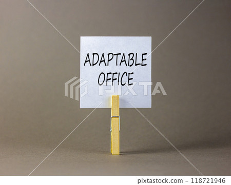 Adaptable office symbol. Concept words Adaptable office on beautiful white paper on wooden clothespin. Beautiful grey background. Business Adaptable office concept. Copy space. 118721946