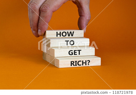 How to get rich symbol. Wooden bloks with words 'How to get rich'. Businessman hand. Beautiful orange background, copy space. Business and how to get rich concept. How to get rich symbol. Wooden bloks with words 'How to get rich'. Businessman hand. Beautiful orange background, copy space. Business and how to get rich concept. 118721978