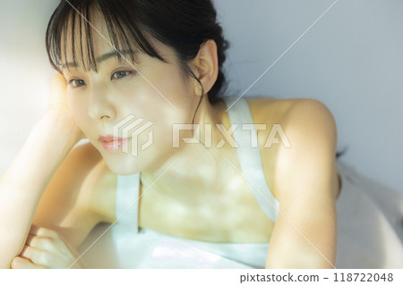 A woman by the window A woman by the window 118722048