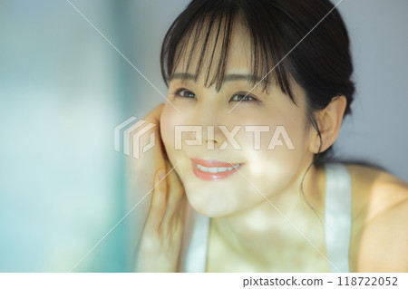 A woman by the window A woman by the window 118722052