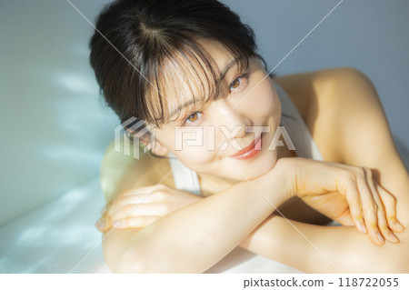 A woman by the window A woman by the window 118722055