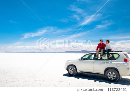 Tourists on white car rooftop in spacious sunshine Salar de Uyuni 118722461
