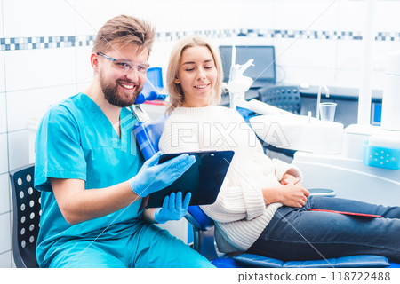 Doctor with patient reading notes form notepad 118722488