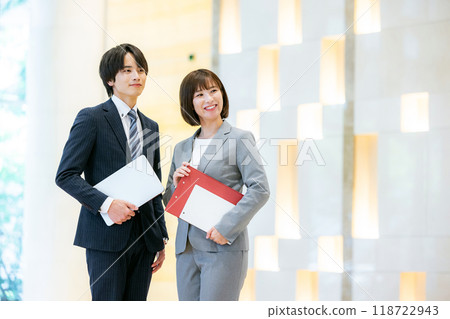 Businessperson standing with a laptop Photo courtesy of Tokyo Electronics College, Denpa Gakuen School Corporation 118722943