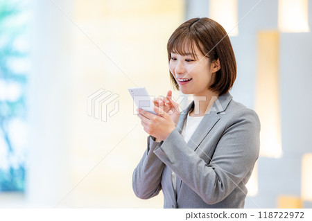 Office lady holding a smartphone Photo courtesy of Denpa Gakuen, Tokyo Electronics College Office lady holding a smartphone Photo courtesy of Denpa Gakuen, Tokyo Electronics College 118722972