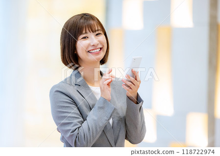 Office lady holding a smartphone Photo courtesy of Denpa Gakuen, Tokyo Electronics College Office lady holding a smartphone Photo courtesy of Denpa Gakuen, Tokyo Electronics College 118722974