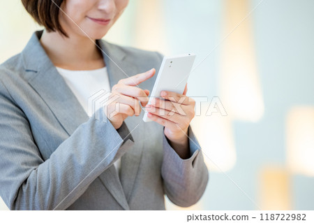 Office lady holding a smartphone Photo courtesy of Denpa Gakuen, Tokyo Electronics College Office lady holding a smartphone Photo courtesy of Denpa Gakuen, Tokyo Electronics College 118722982