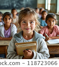 A young girl smiles brightly, holding a new textbook in a rural classroom. Wooden desks surround her as other girls learn, symbolizing the hope and excitement for equal education. 118723066