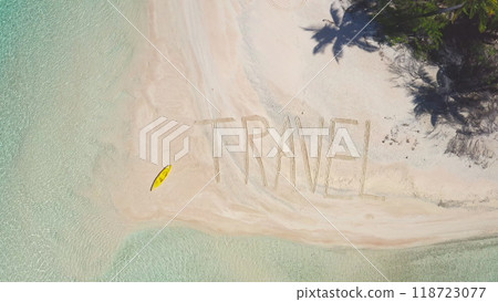 Yellow kayak on sandy beach in Tikehau, French Polynesia, world travel written on sand, creating inspiring scene of wanderlust, freedom. Summer holidays on tropical island concept. Aerial drone shot 118723077