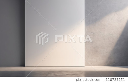 A large white wall stands in a room with concrete floors. Sunlight streams in through a window, casting shadows across the space 118723251