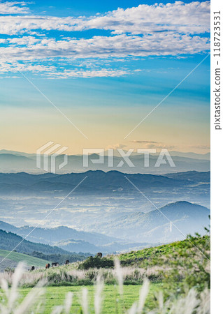 A view of the town and grazing cows from the top of the mountain 118723531