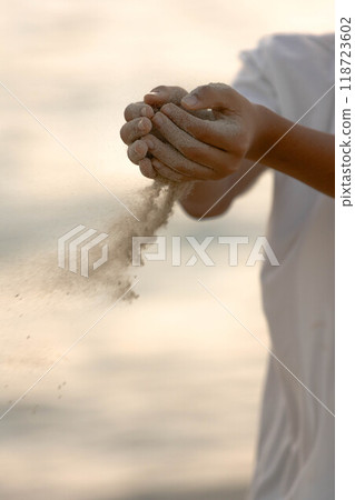 Spilling sand on the beach in the sunset 118723602