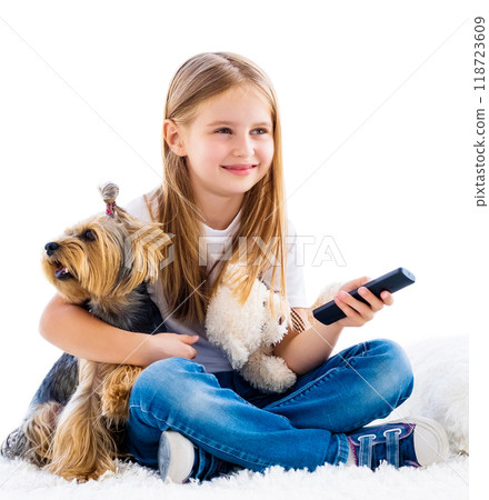 Cute girl and her dog switching channels with tv remote isolated on white Cute girl and her dog switching channels with tv remote isolated on white 118723609