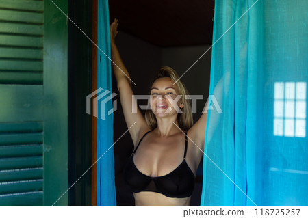 Pretty sexy young passionate woman with a beautiful slim body in stylish white lingerie posing on a sunny morning. Fashionable lingerie collection Pretty sexy young passionate woman with a beautiful slim body in stylish white lingerie posing on a sunny morning. Fashionable lingerie collection 118725257