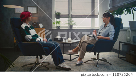 Teenage girl shares emotions during consultation with psychologist Teenage girl shares emotions during consultation with psychologist 118725264