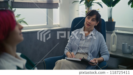 Teen girl talks to psychotherapist or psychologist during consultation Teen girl talks to psychotherapist or psychologist during consultation 118725411