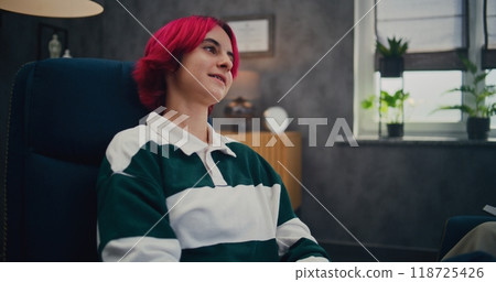 Pink-haired teen girl with braces on consultation with psychologist Pink-haired teen girl with braces on consultation with psychologist 118725426