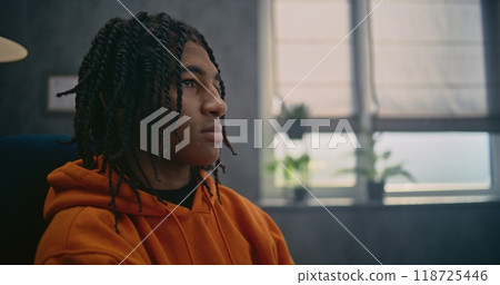 African American teenager discusses psychological trauma during therapy session 118725446