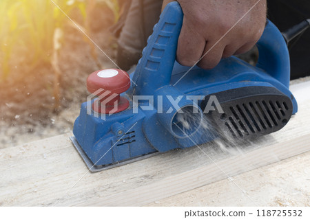 Worker is planing boards Worker is planing boards 118725532