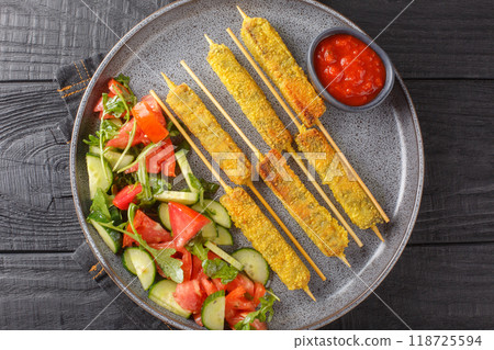 Vegan Kebab Sticks Breaded Eggplant Served with Vegetable Salad and Tomato Sauce Close-up on Plate. Horizontal top view 118725594