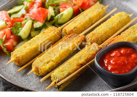 Vegetarian Breaded Eggplant Sticks served with vegetable salad and tomato sauce close-up on a plate. Horizontal 118725604