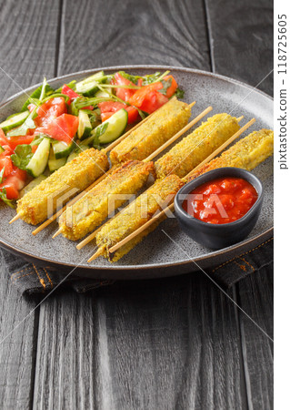 Breaded Eggplant Sticks with Mozzarella Cheese Served with Fresh Salad and Sauce Close-up on Plate. Vertical Breaded Eggplant Sticks with Mozzarella Cheese Served with Fresh Salad and Sauce Close-up on Plate. Vertical 118725605