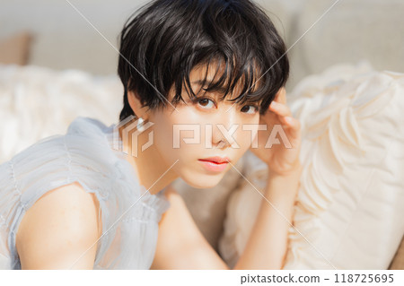 Woman leaning on sofa 118725695