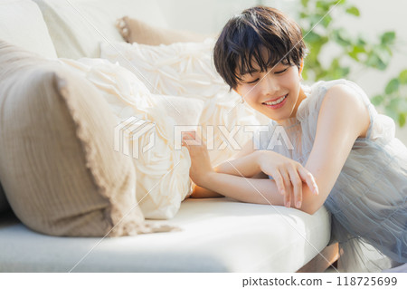 Woman leaning on sofa 118725699