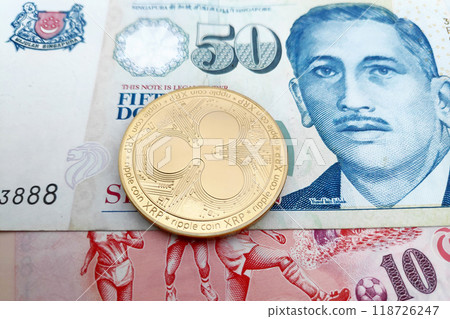 Ripple on top of a stack of Singaporian Dollars 118726247