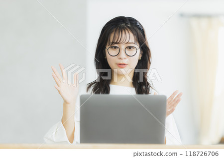 A woman drinking a hot drink 118726706