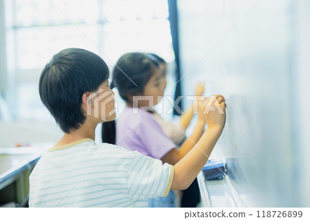 Elementary school students taking lessons in a classroom Elementary school students taking lessons in a classroom 118726899