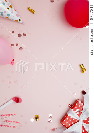 Birthday attributes colorful balloons, party hats, candles, and confetti. Concept of festive birthday celebrations 118727811
