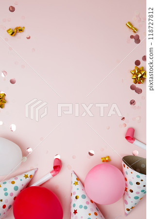 Birthday attributes colorful balloons, party hats and confetti. Concept of festive birthday celebrations 118727812