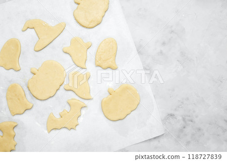 Making different shapes of fall cookies for Halloween. Dough with cookie cutter 118727839
