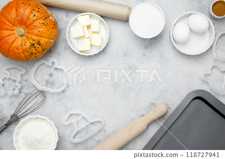 Ingredients for baking Halloween cookies including flour, butter, sugar, spices, eggs and pumpkin. Seasonal autumn baking 118727941