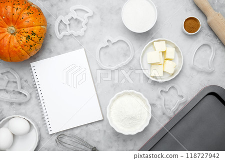 Ingredients for baking cookies for Halloween, notepad mock-up for writing down the recipe. Seasonal autumn baking 118727942