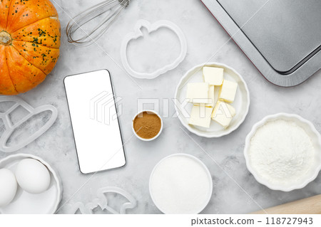 Ingredients for baking cookies for Halloween, smartphone mock-up. Seasonal autumn baking Ingredients for baking cookies for Halloween, smartphone mock-up. Seasonal autumn baking 118727943