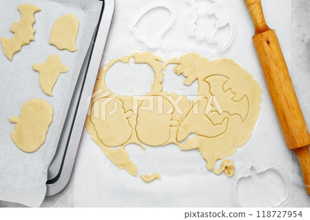 Making different shapes of fall cookies for Halloween. Dough with cookie cutter Making different shapes of fall cookies for Halloween. Dough with cookie cutter 118727954