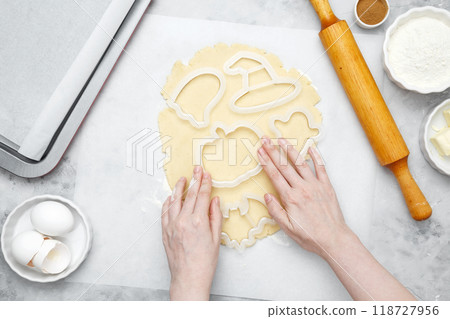 Making different shapes of fall cookies for Halloween. Dough with cookie cutter Making different shapes of fall cookies for Halloween. Dough with cookie cutter 118727956